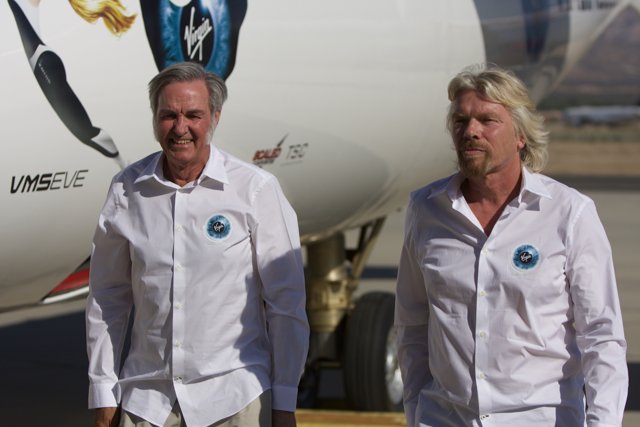 Two Men in White Shirts Posed by an Airplane