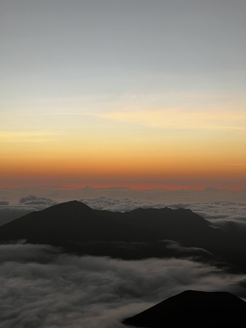 Sun rising over the clouds from Mauna Kea