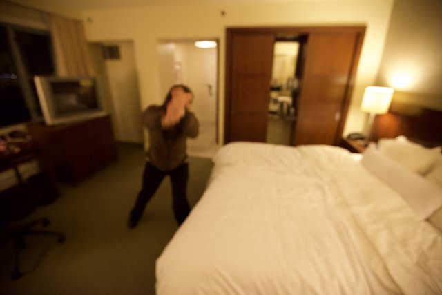 Blurry Hotel Room Man with Computer Monitor