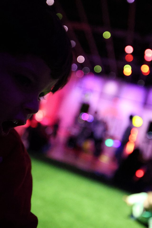 Silhouette Against Colorful Bokeh Lights at Baby Rave