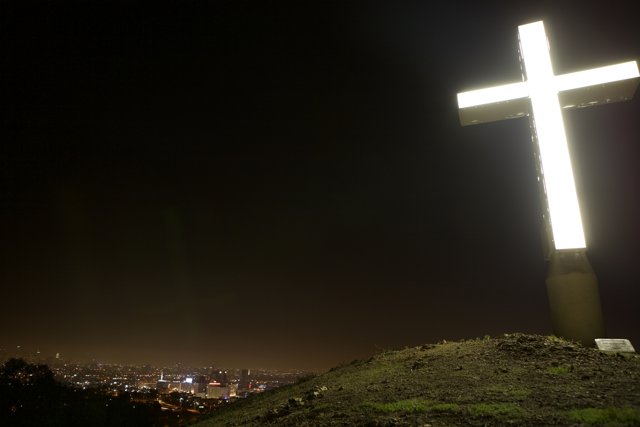 Illuminated Cross on Hilltop