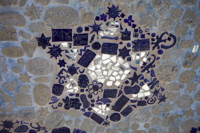 Blue and White Mosaic Star on Walkway Wall