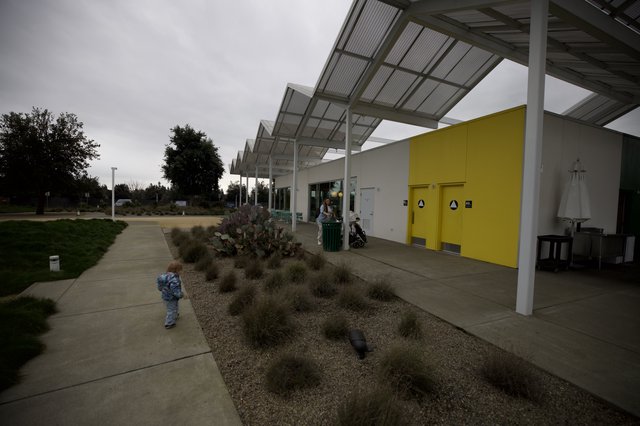 Child Explores Modern Community Center Courtyard