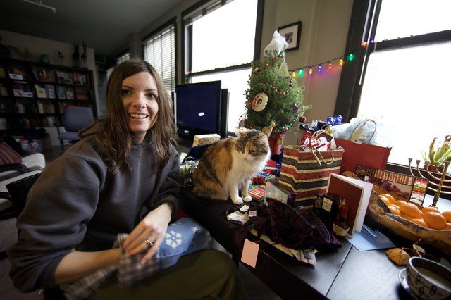 Holiday Joy: Woman and Cat Amid Christmas Gifts
