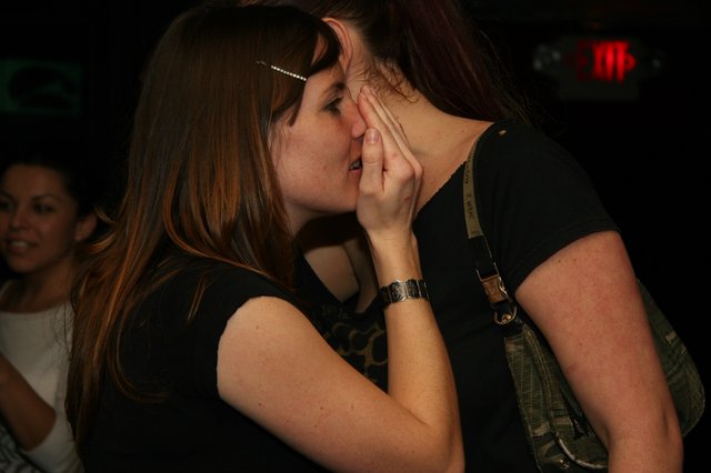 Two Women Share an Intimate Kiss at Nightclub