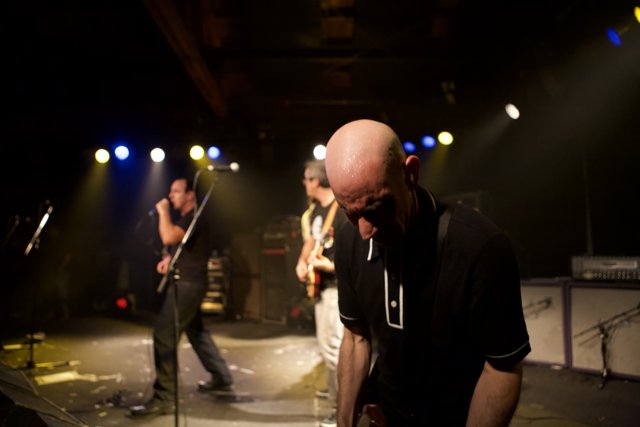 Rocking the Stage: A Bald Headed Guitarist in Bad Religion Glasshouse Concert