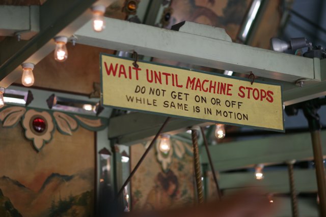 Wait Until Machine Stops Sign in Industrial Cafeteria