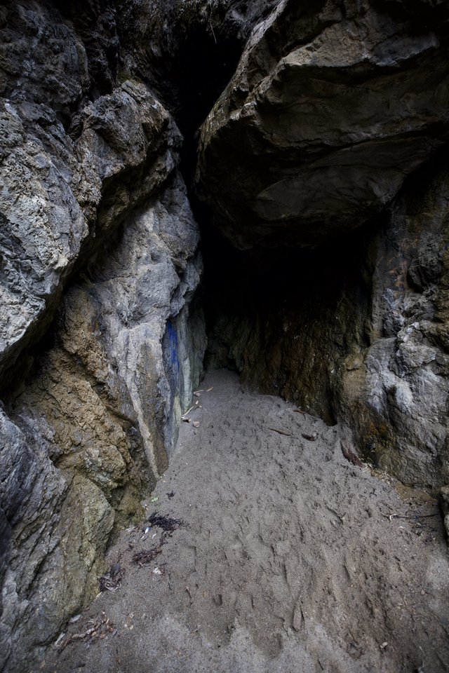 Dark Cave Entrance Framed by Ancient Rocky Walls