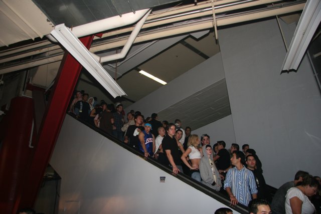 A Crowd of 31 People on a Staircase with Handrail