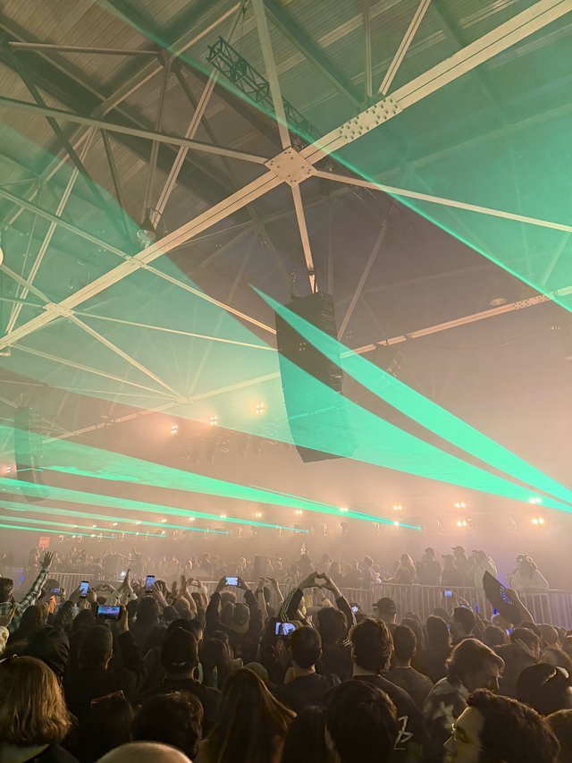 Concert Crowd Under Green Laser Light Show