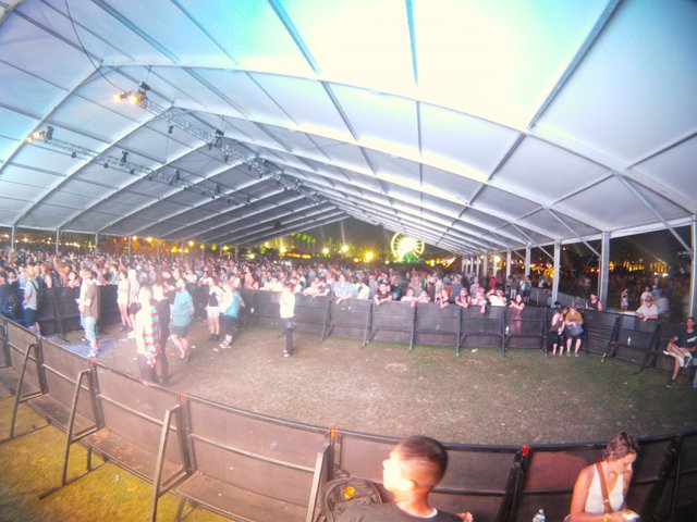 Concert Crowd in Outdoor Tent Venue