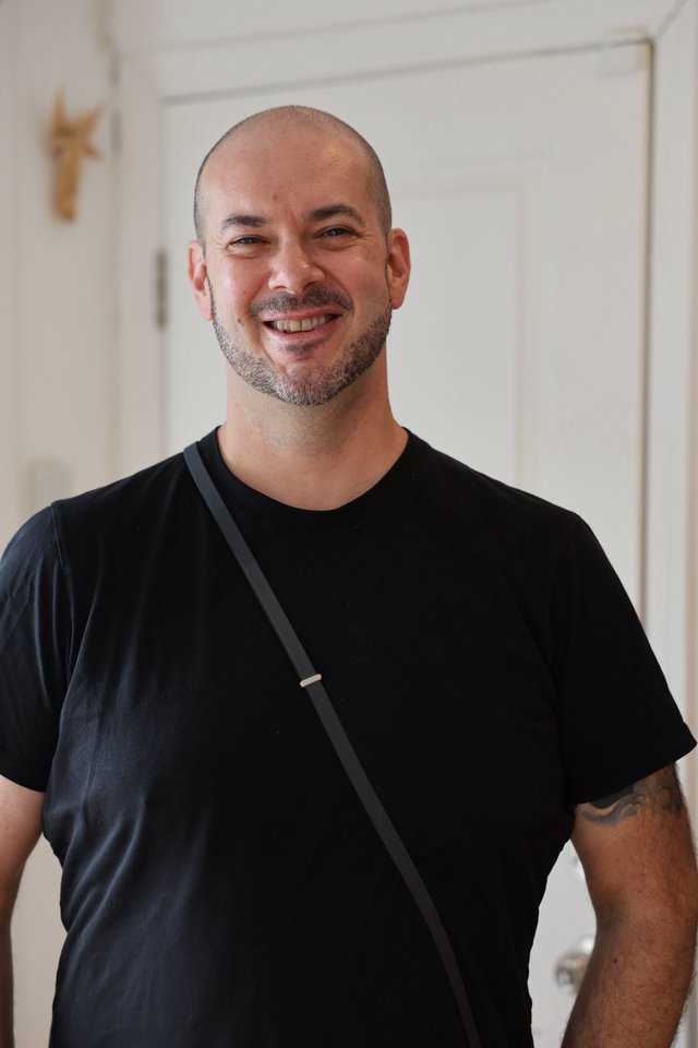 Warm Portrait of Smiling Man in Black T-Shirt