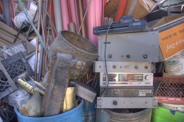 Radio and Other Devices amidst Pile of Manufacturing Waste