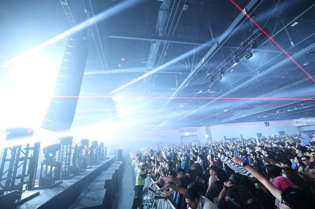 Massive Indoor Rave Crowd Engulfed in Laser Light