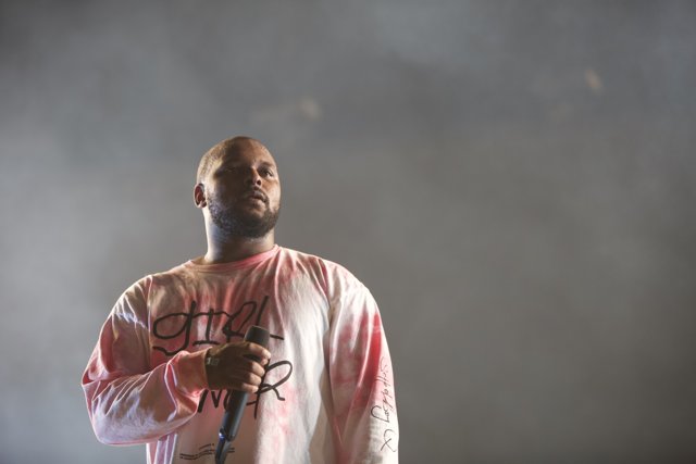 ScHoolboy Q rocks the stage in a pink T-Shirt