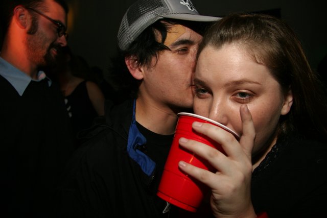 New Year's Kiss with Red Cup in Hand