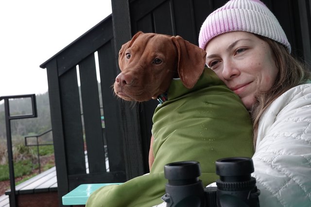 Woman and Dog Share Winter Moment Outdoors