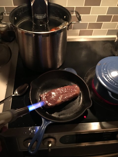 Sizzling Steak on a Cooking Pan