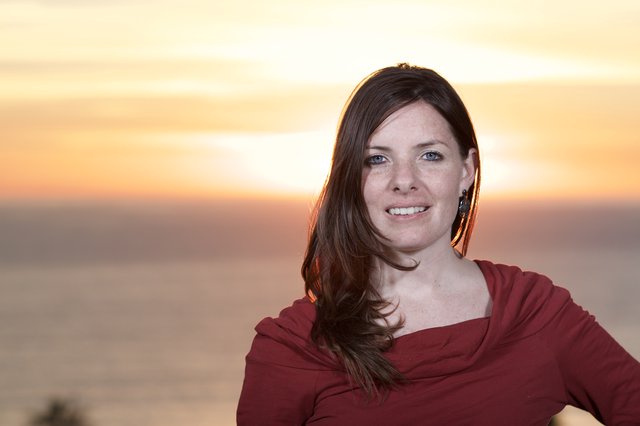 Woman Smiling at Golden Hour Ocean Sunset