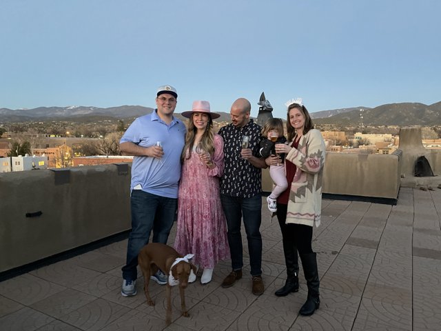 Family Portrait on Santa Fe Rooftop with Their Beloved Pup