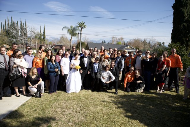 Wedding Party Poses Under a Clear Blue Sky