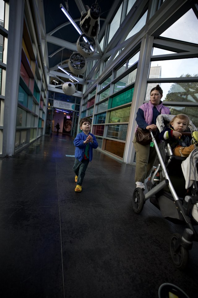Family Explores Interactive Science Museum Corridor