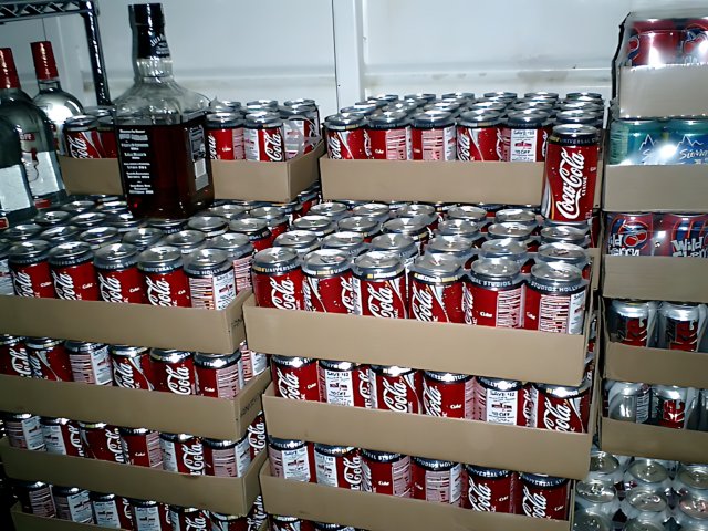 Coca-Cola Cans Piled High in Warehouse