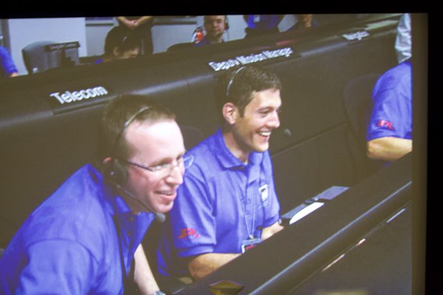 Blue-Shirted Men Smiling for the Camera