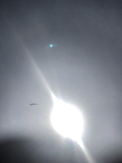 Sun Flare Above High-Flying Plane