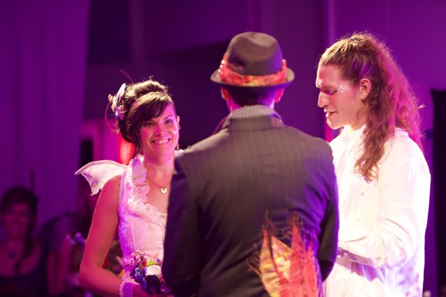 Smiling Bride and Groom in Purple Fedora Hats