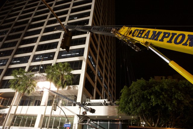Construction Crane Hoists Office Building at Night