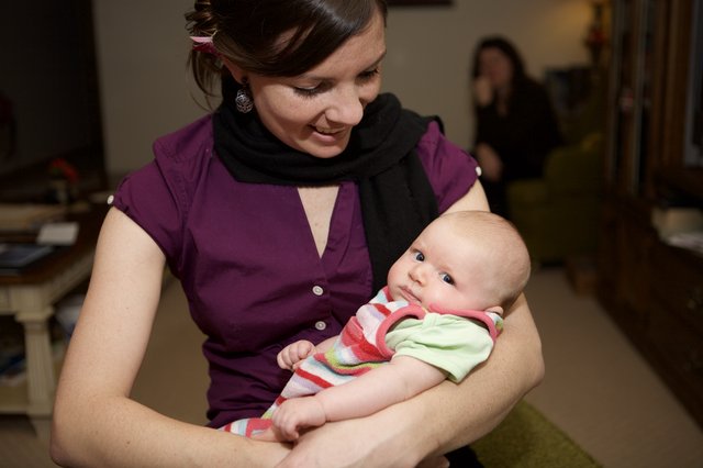 New Mother Lovingly Cradles Her Newborn Baby