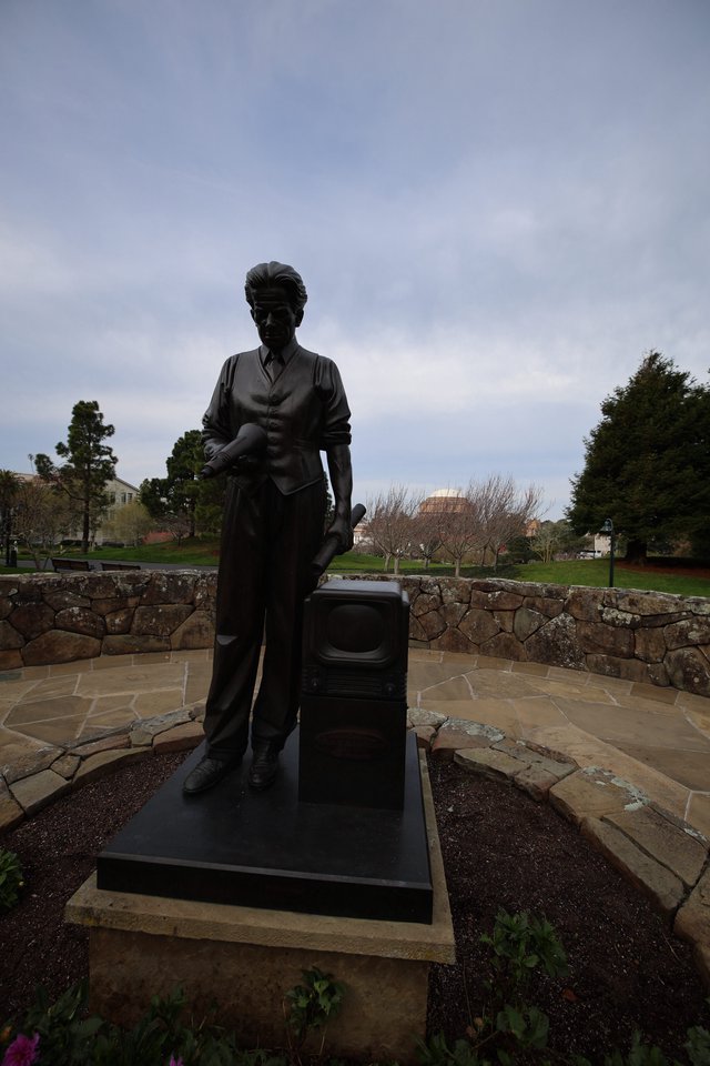 Bronze Statue of Woman with Suitcase at Memorial