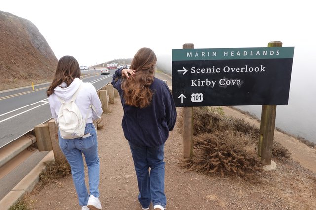 Visitors at Marin Headlands Scenic Overlook Sign