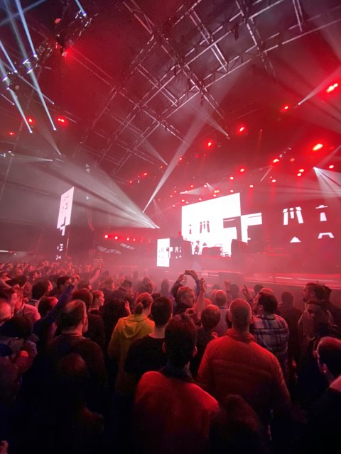 Red Spotlight on a Crowded Nightclub Performance
