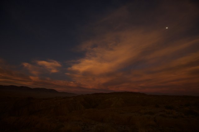 Desert Sunset with the Moon and a Cloud
