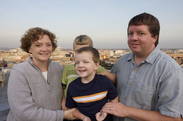Family Portrait at Sunset Overlooking City Skyline
