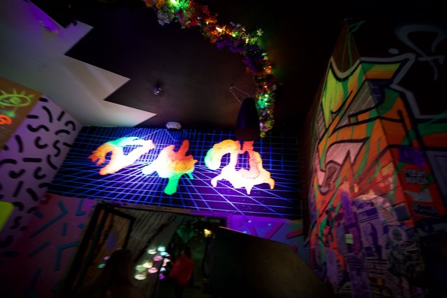 Vibrant Neon Vaporwave Art Installation in Dark Gallery Space