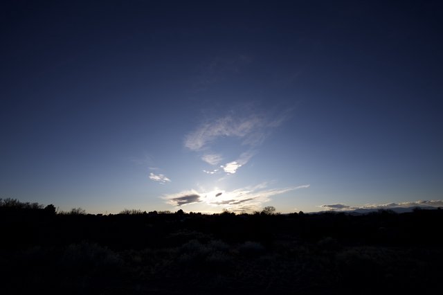 Twilight Sky Over Desert Landscape with Wispy Clouds