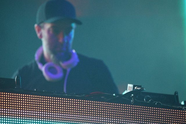 DJ Performs Behind Glowing LED Stage Setup