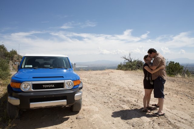 Hugging in Front of a Blue Truck