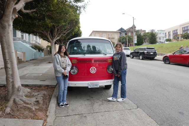 Two Friends Posing with Classic Volkswagen Bus