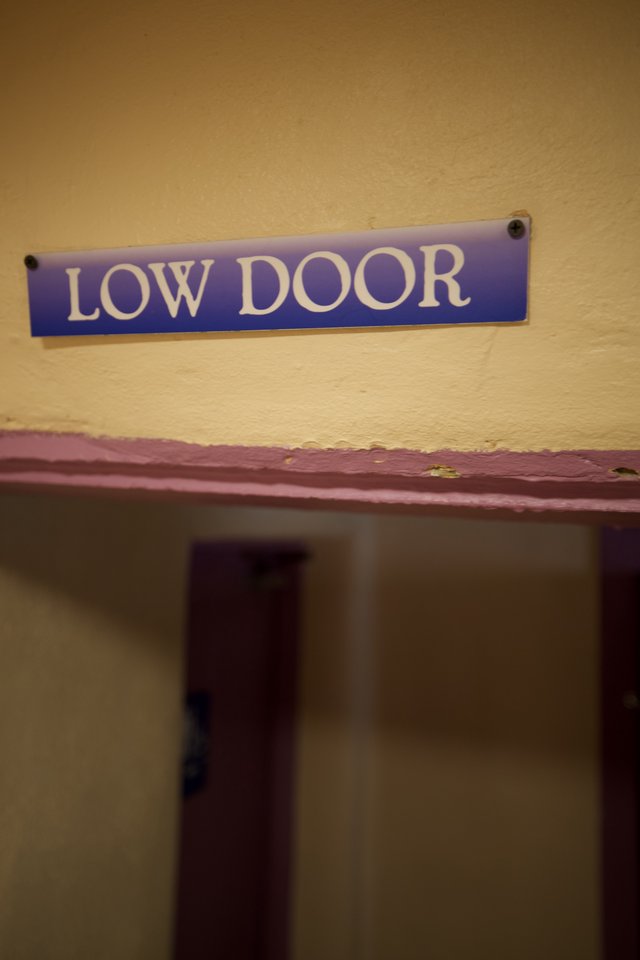 Low Door Sign in Historic Building
