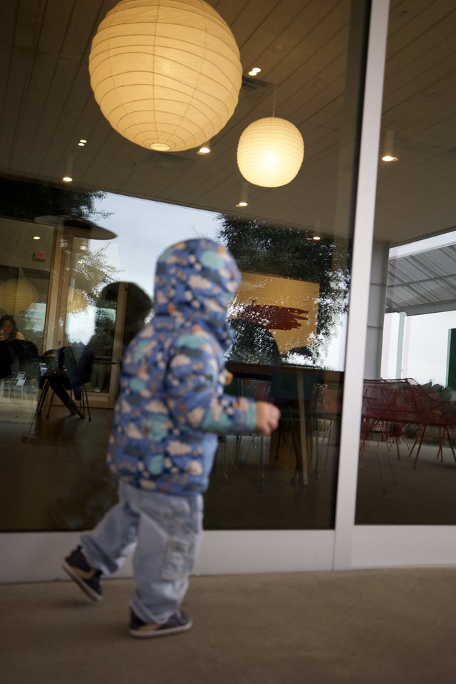 Child in Motion Outside Modern Restaurant