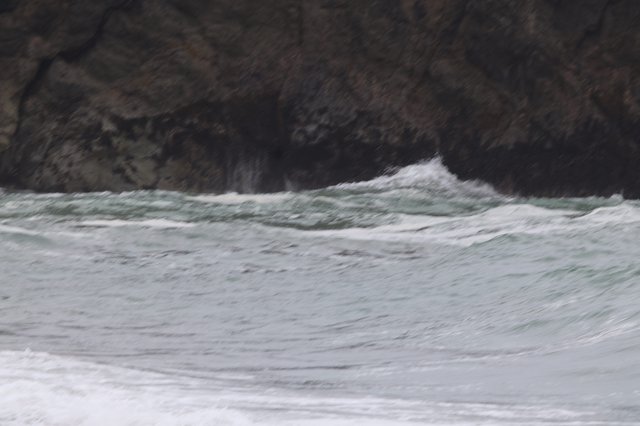 Wild Waves Crash Against Rugged Coastal Cliffs