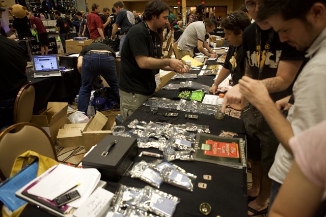 Tech Enthusiasts Gather around Electronics Table