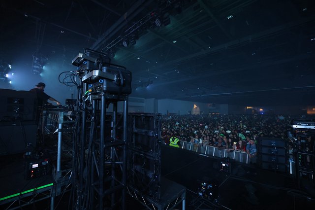 DJ Performs Before Massive Indoor Festival Crowd