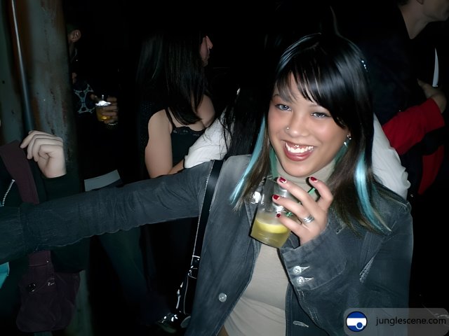 Blue-haired Woman Sipping a Drink at the Club