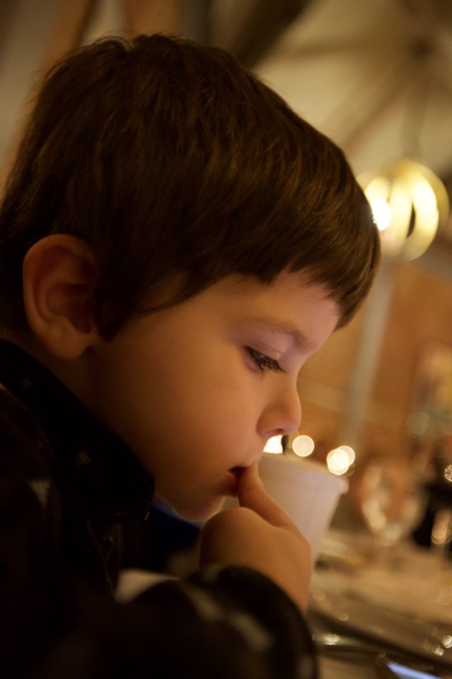 Young Boy Lost in Thoughtful Contemplation by Candlelight