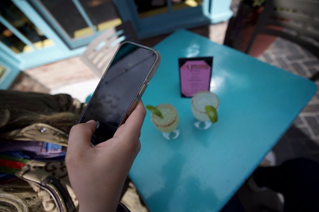 Phone Check at Outdoor Cafe Table